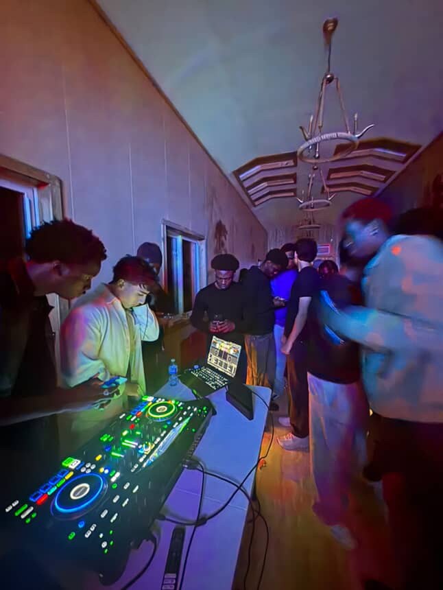 DJ and guests enjoying an indoor celebration